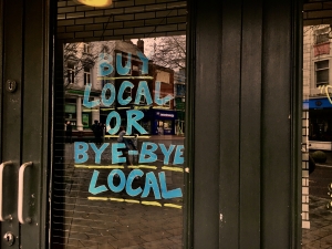 Business shop front with blue writing on the window.