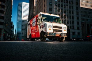 A truck parked on the street in the city, the truck is red and white!