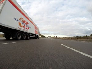 A truck driving down a high way really fast