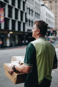 Delivery person holding parcels 
