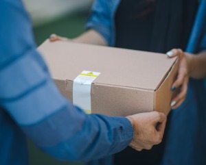 courier handing customer a box